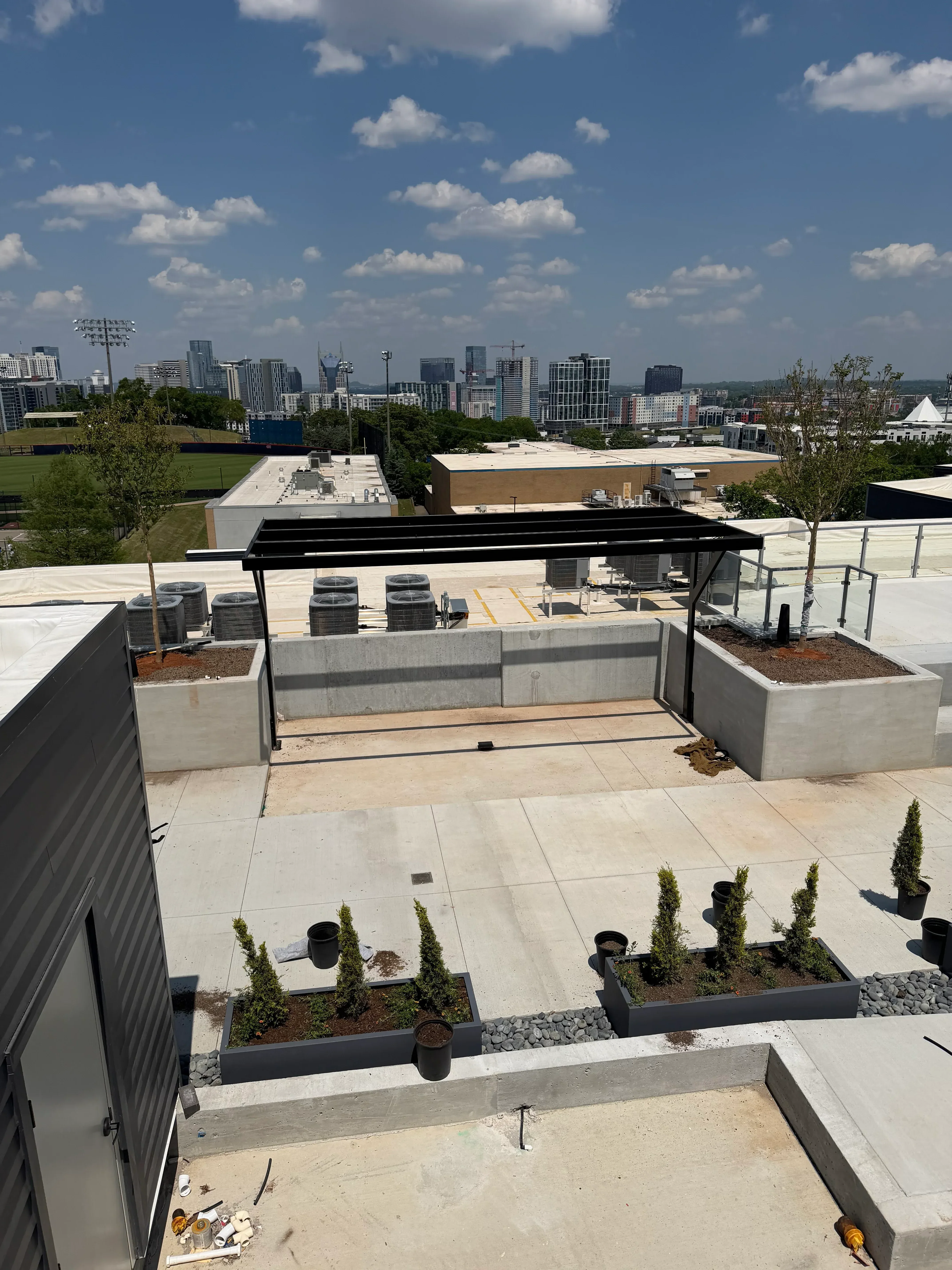Black metal railing and planter boxes on residential exterior stairs with concrete landing