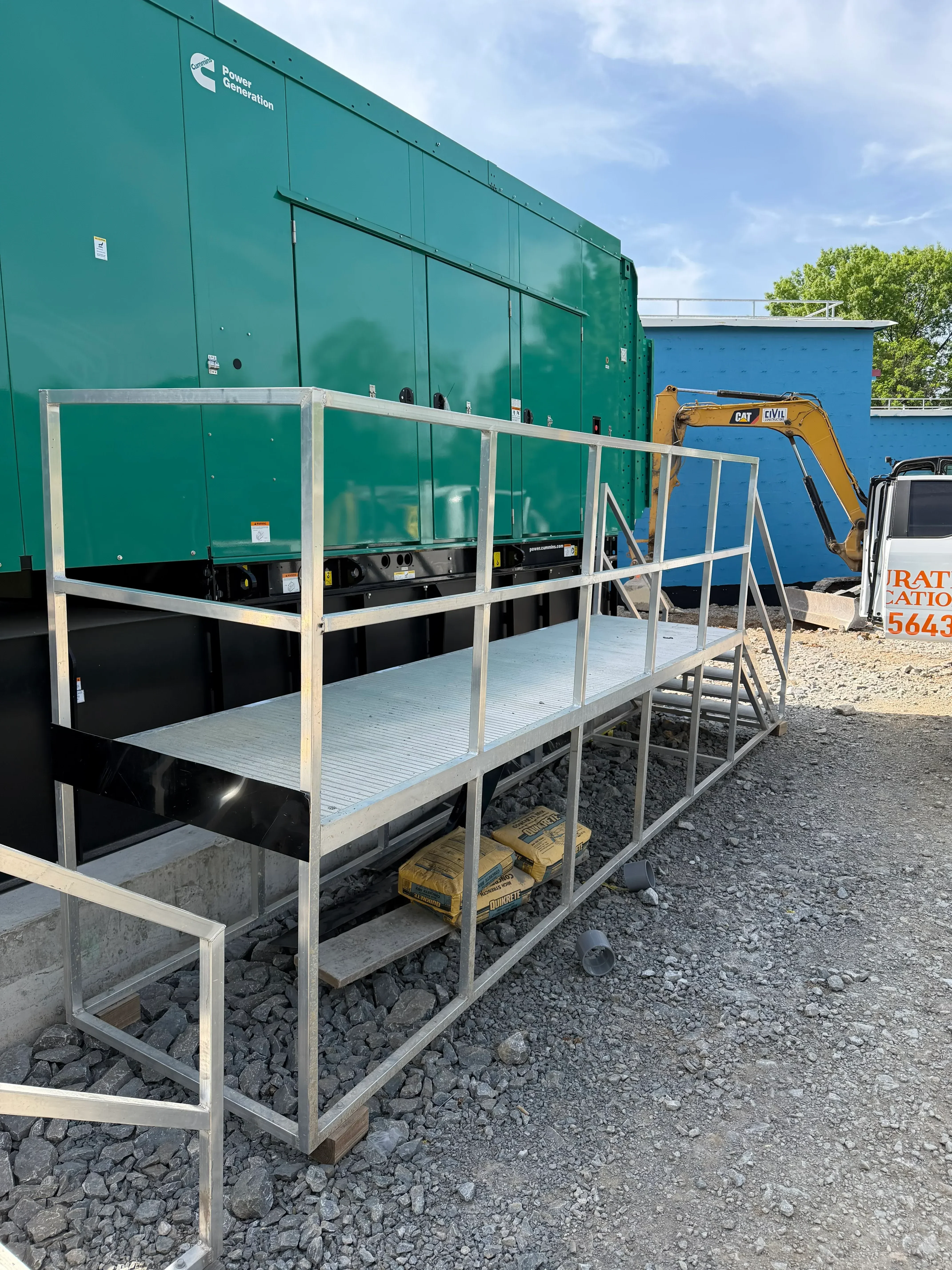 Welded steel stair frame with aluminum treads and risers installed on commercial equipment