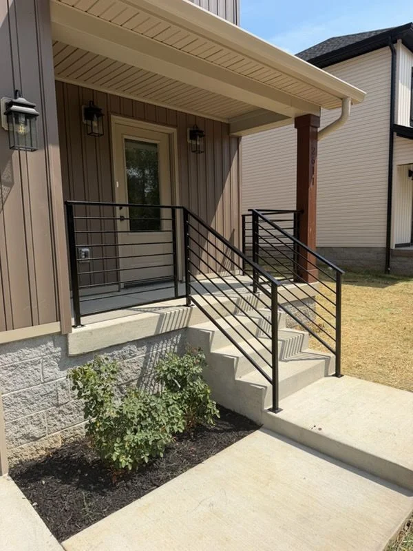 Custom metal staircase designed and fabricated by Accurate Fabrication installed in a Nashville-area home with an open floor plan. The staircase features clean lines and a finished metal structure suited to the home's interior layout.