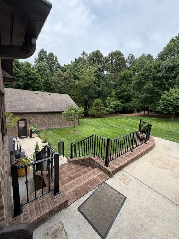 Newly installed metal staircase inside a Nashville-area home, showing steel stringers and treads fitted to an open interior stair well. The finished installation connects two floor levels with clean, straight metalwork typical of residential builds across Middle Tennessee.